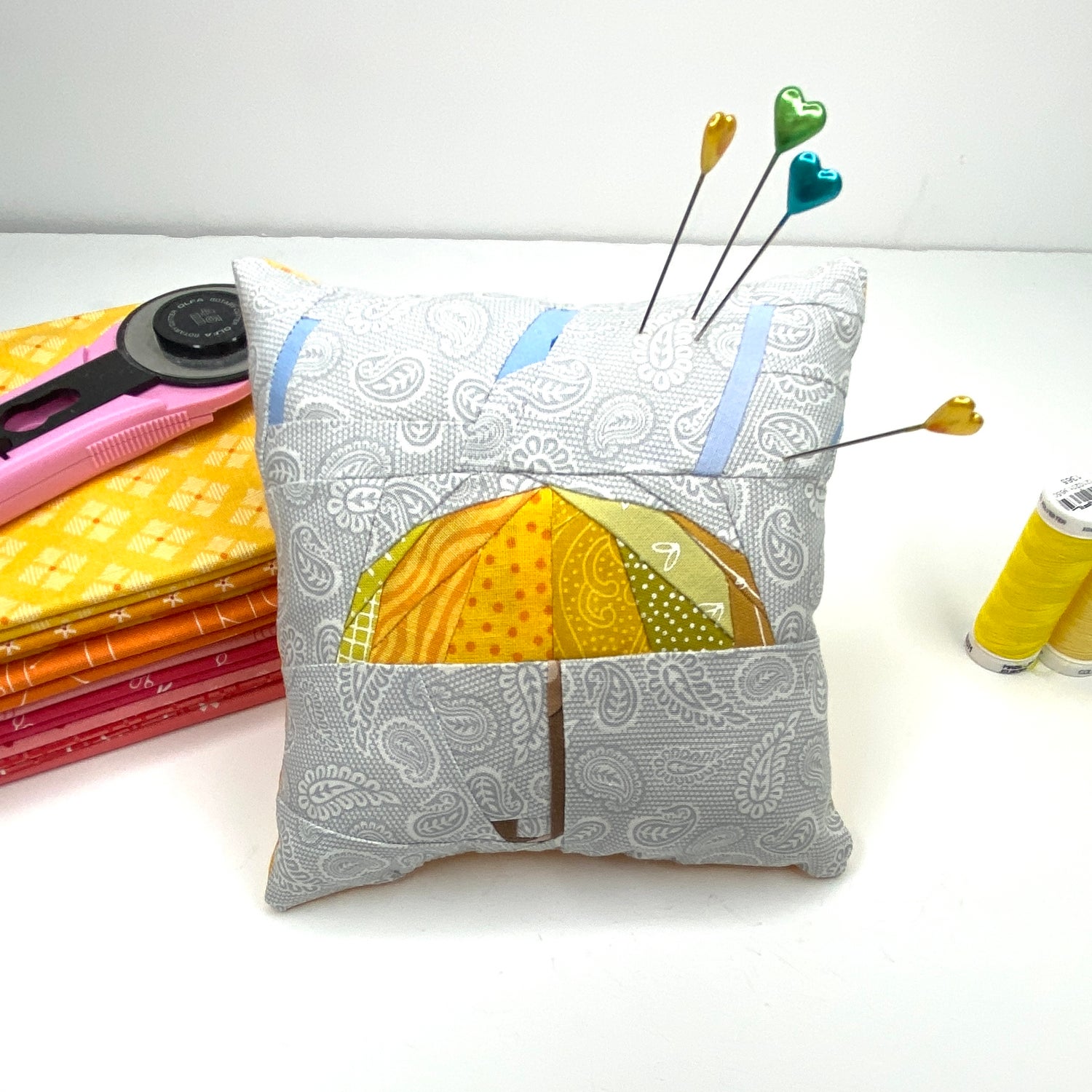 A Foundation paper pieced Quilt Block has been turned into a pin cushion. Scrappy Quilt Block, Umbrella Quilt Block, DIY Pin Cushion, Orphan Quilt Block, Sewing Project, Patchwork Quilting.