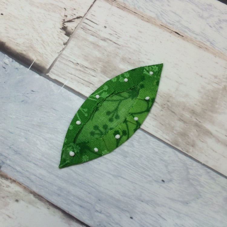 prepared EPP leaf shape with small dots of white glue in seam allowance