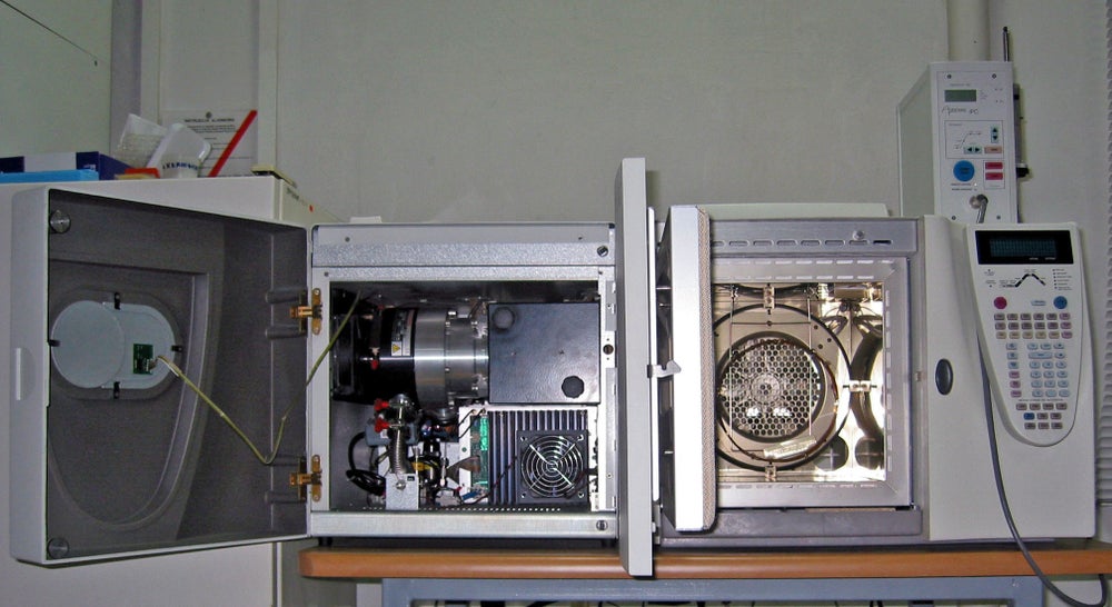 A gas chromatograph (right) directly coupled to a mass spectrometer (left)