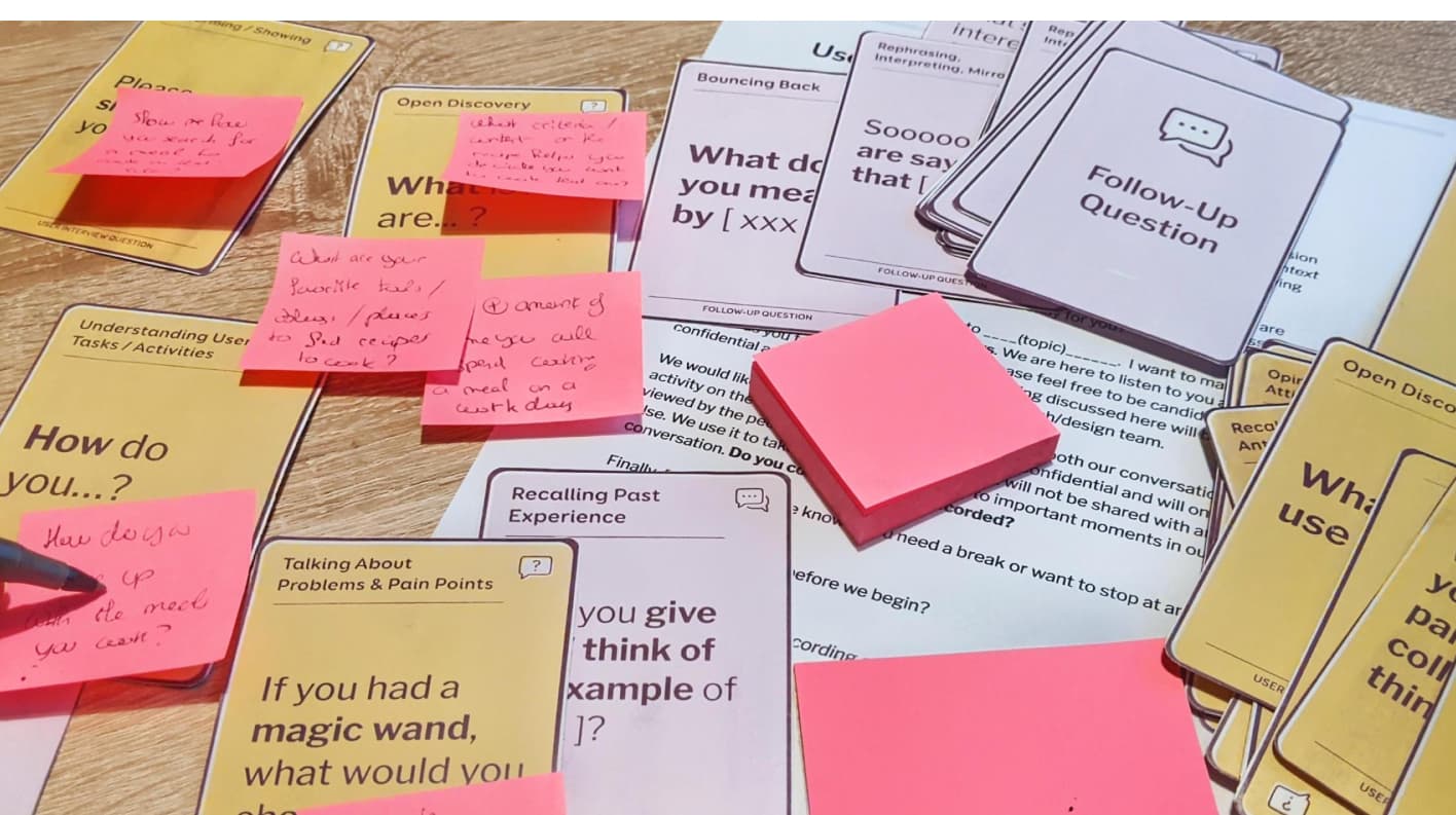 Some user interview cards on a table with stick notes