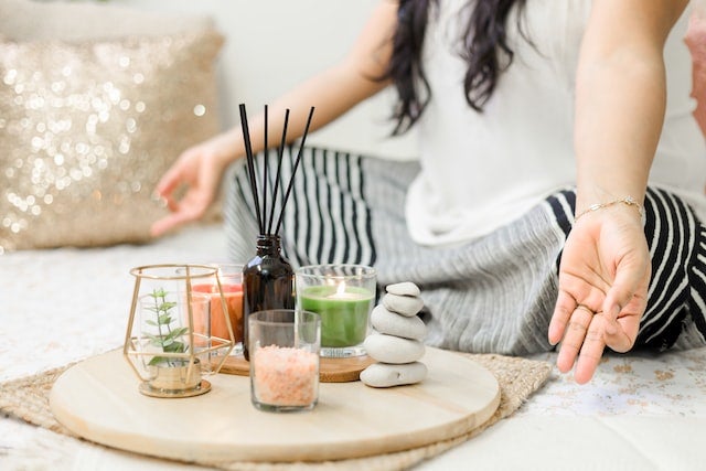 meditation space with candles, smoothie, essential oils for a home mental health gym