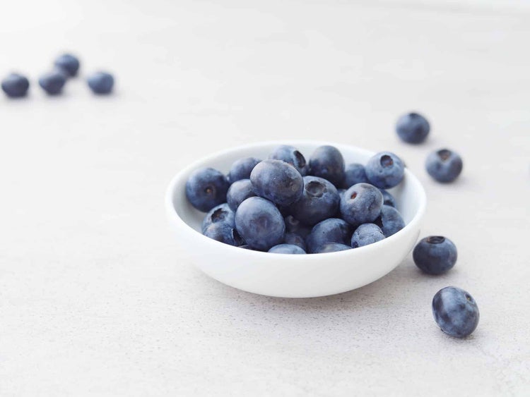 bowl of blueberries on a white countertop as part of the Blue Zones diet for longevity