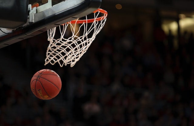 NCAA March Madness Basketball games start today. Picture shows basketball flowing through the basketball.